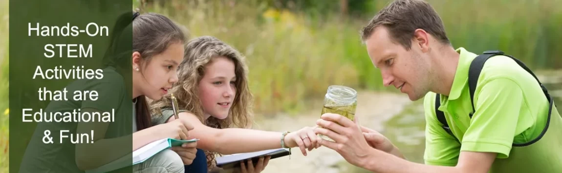 Male teacher showing 2 girls the contents of a water sample while out in the field.